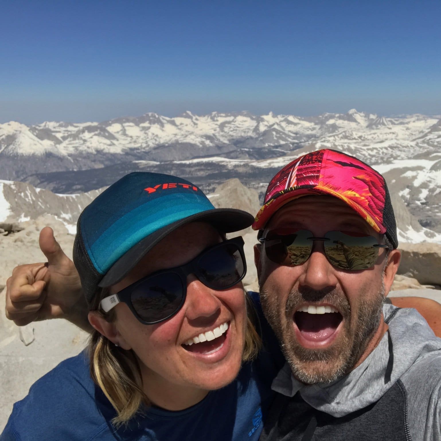 a candid shot of commerical photographer, Nikki Ritcher, and friend atop snowy mountains.